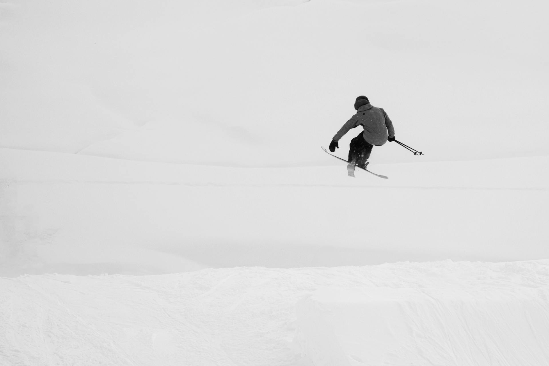skiing person jumps of a ramp