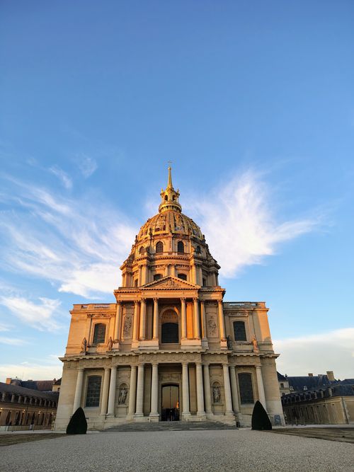 Free Beautiful golden hour view of the Les Invalides dome in Paris, France with blue sky backdrop. Stock Photo