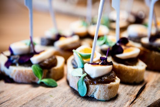 Delicious rustic appetizers featuring quail eggs, greens, and chutney on sliced baguettes, perfect for gourmet events.