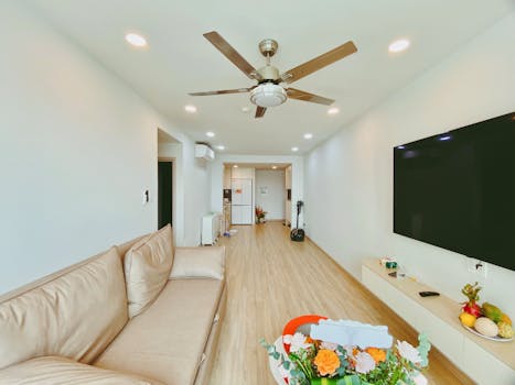 Spacious living room featuring modern decor and open layout with a ceiling fan.