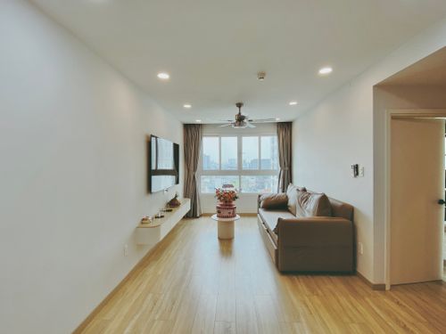 Free Spacious living room featuring modern decor, cozy sofa, and large city view window. Stock Photo