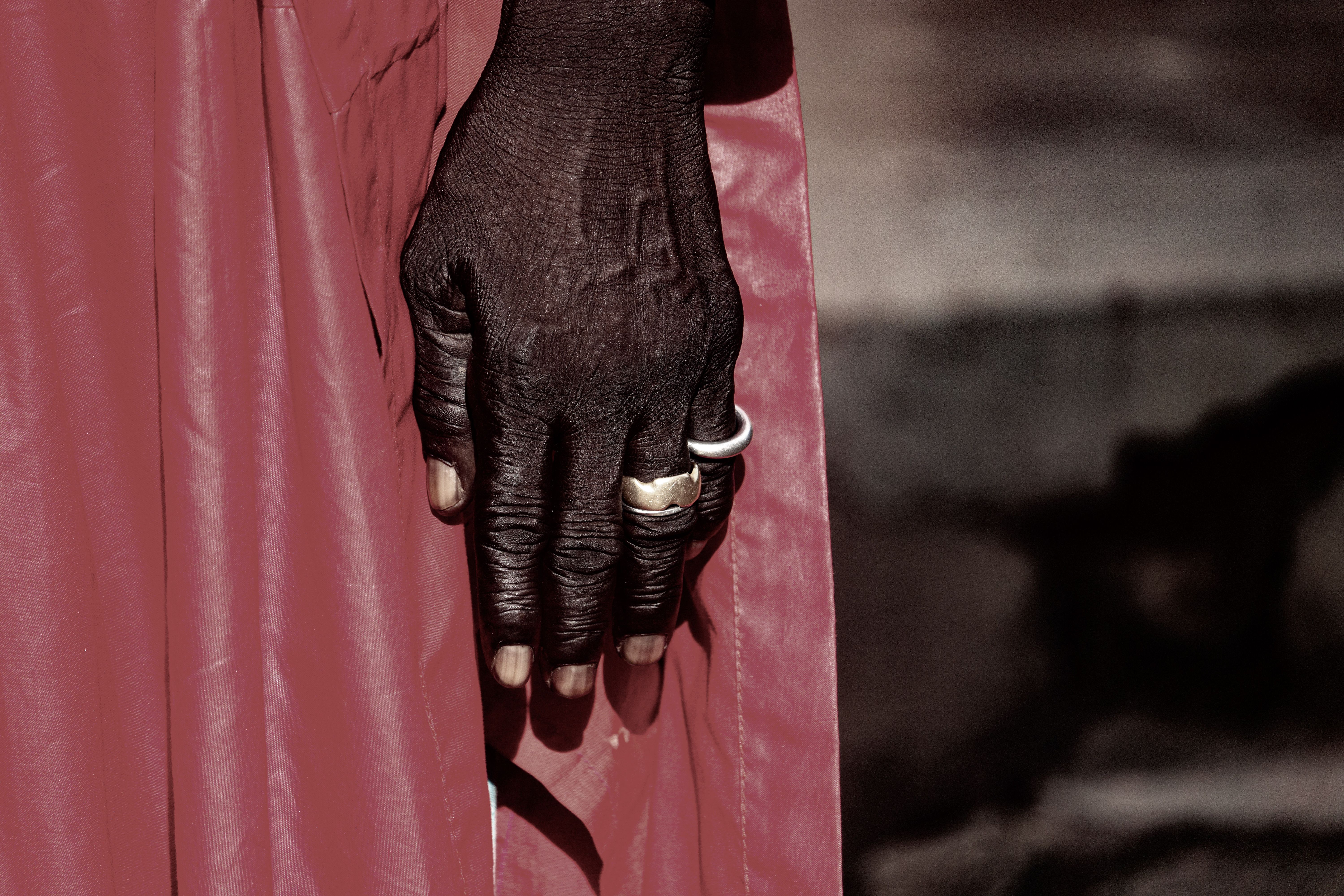 Close-up of Hand with Rings against Red Fabric · Free Stock Photo