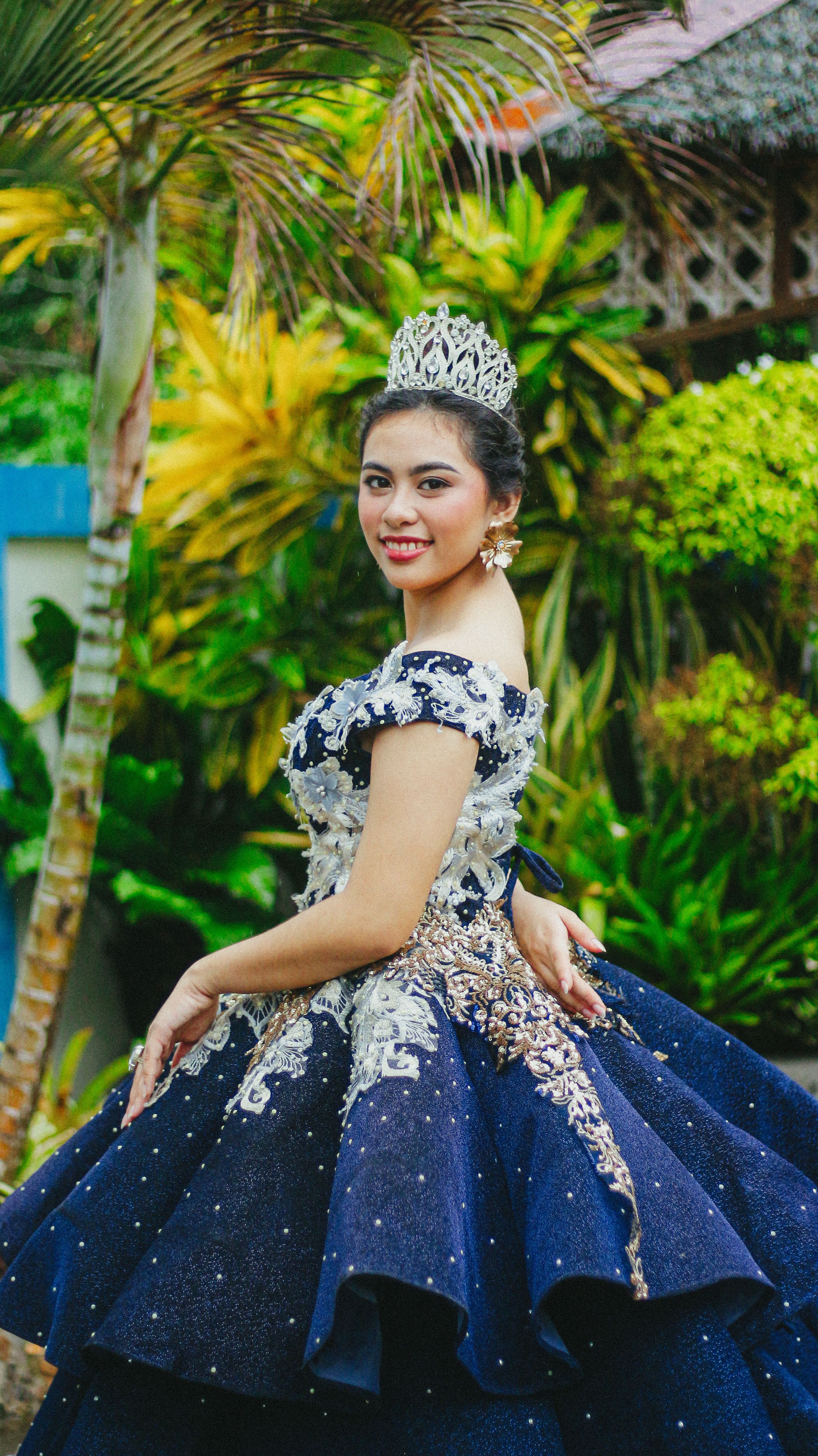 Elegant Woman in Blue Gown with Tiara Outdoors · Free Stock Photo