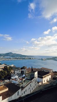 Breathtaking view of Ibiza's coastline with Mediterranean Sea and blue skies.
