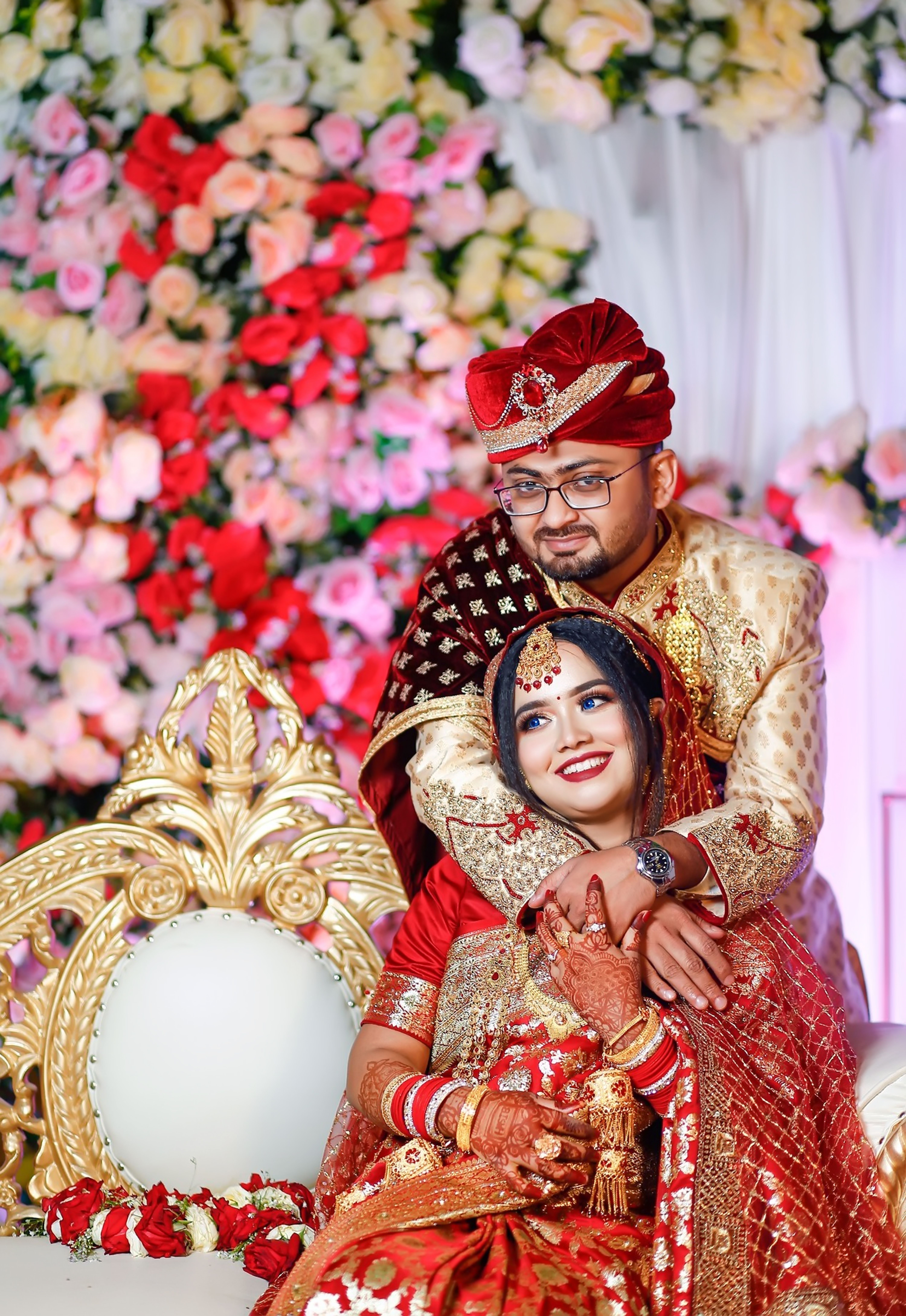 Beautiful bride and groom in traditional attire at a vibrant Indian wedding.