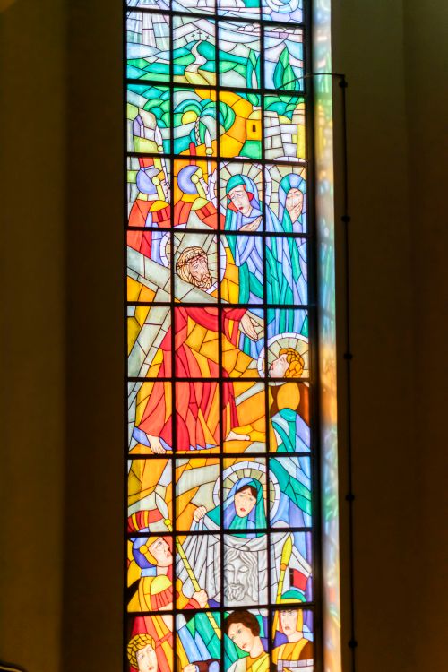 Free Detailed stained glass window depicting biblical scenes in a historic church in Wrocław. Stock Photo