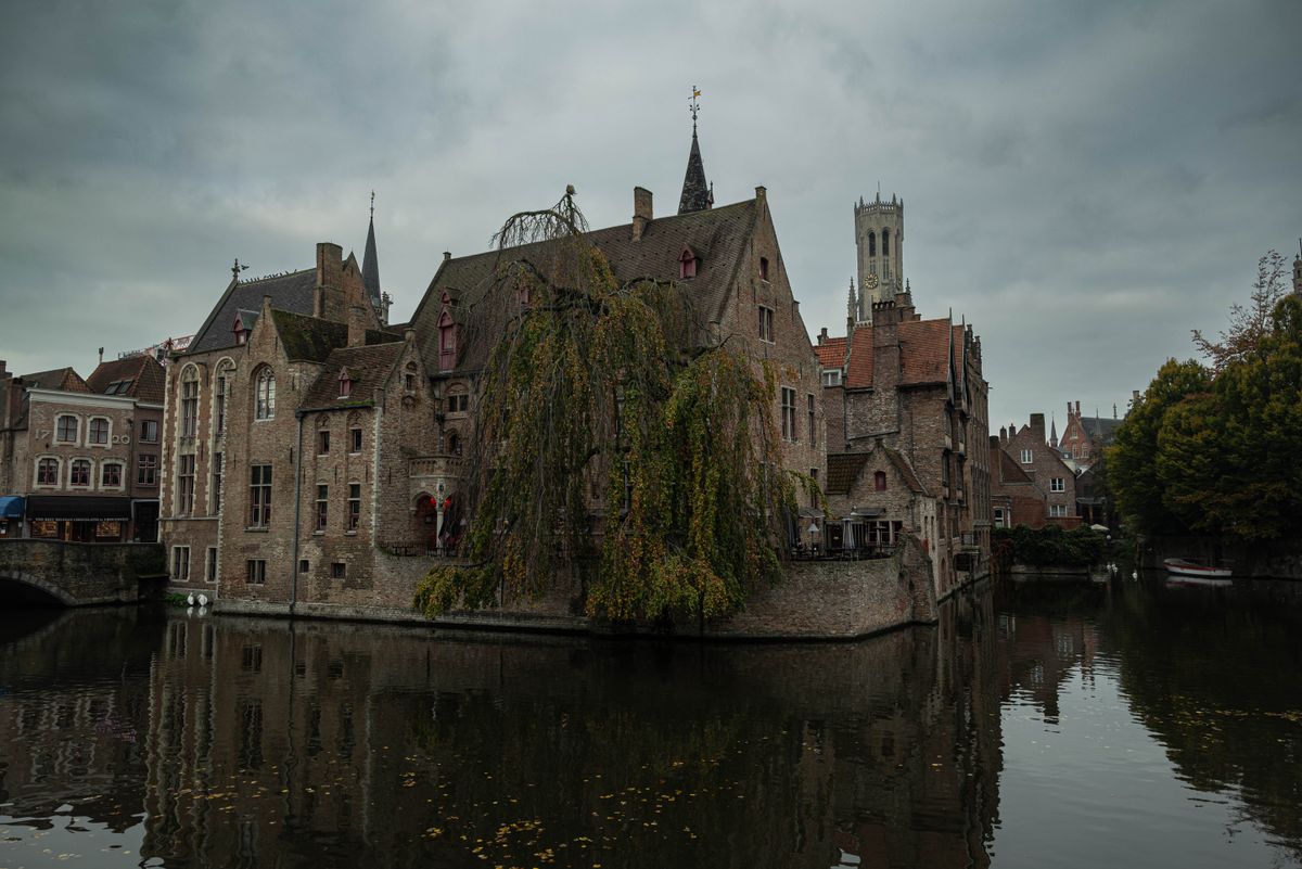 Medieval architecture reflected in serene canal waters in Bruges