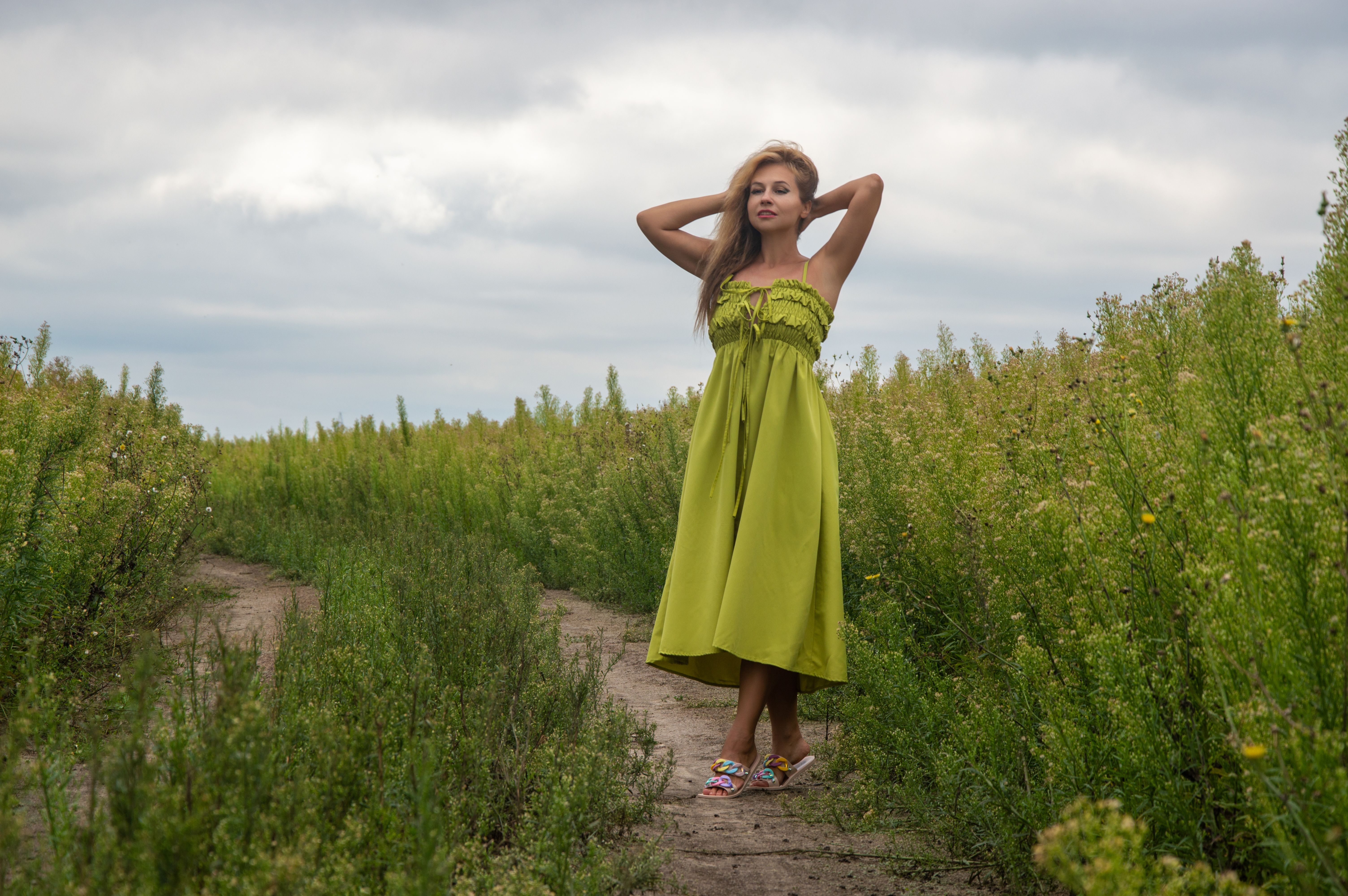 Woman in Green Dress Posing in a Field · Free Stock Photo