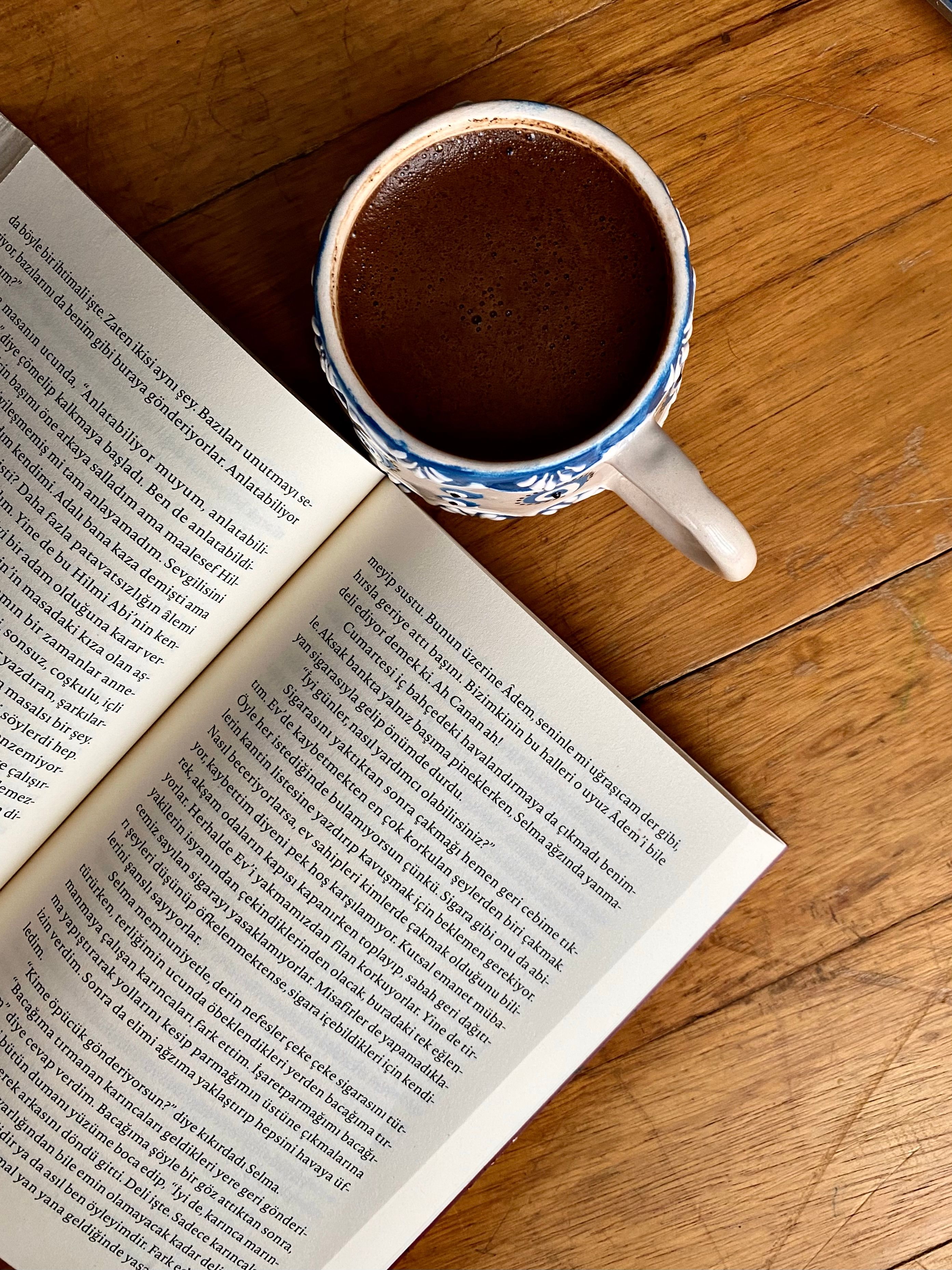 Cozy Reading Scene with Book and Coffee · Free Stock Photo