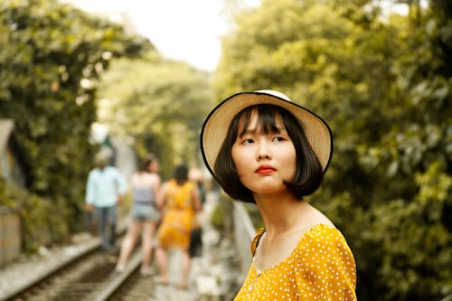 Woman Wearing Yellow Dress and Hat