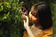 Woman Touching A Plant