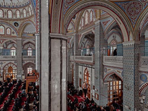 Free Vibrant interior of a mosque filled with worshippers, showcasing Islamic architectural beauty. Stock Photo