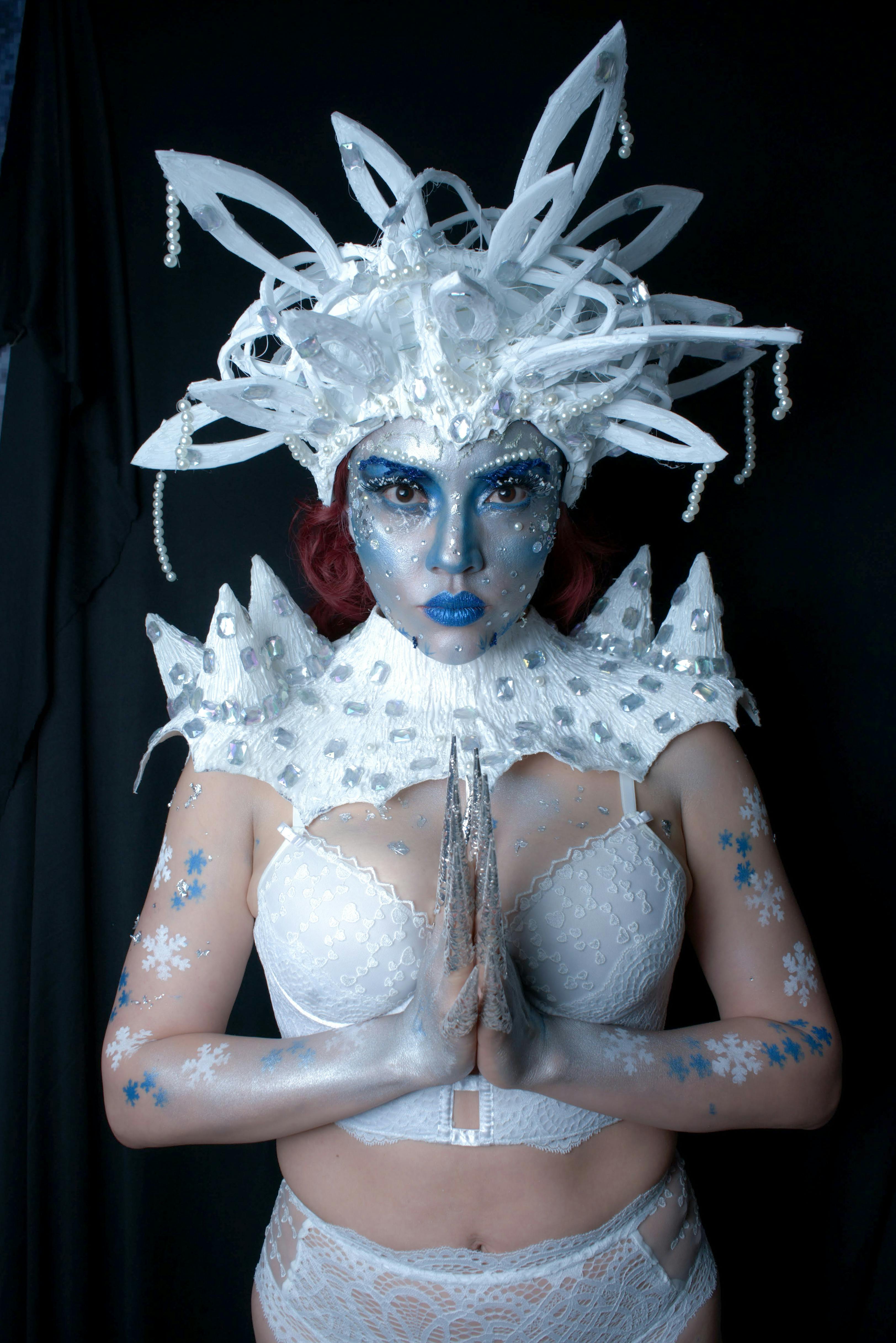 A striking portrayal of a fantasy ice queen with elaborate makeup and costume.