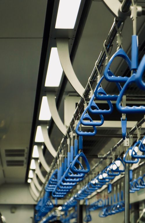 Free Interior of a subway train showcasing blue handrails and modern design. Stock Photo