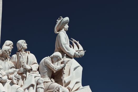 Monument to the Discoveries in Lisbon, Portugal, showcasing historic explorers under a vibrant blue sky.