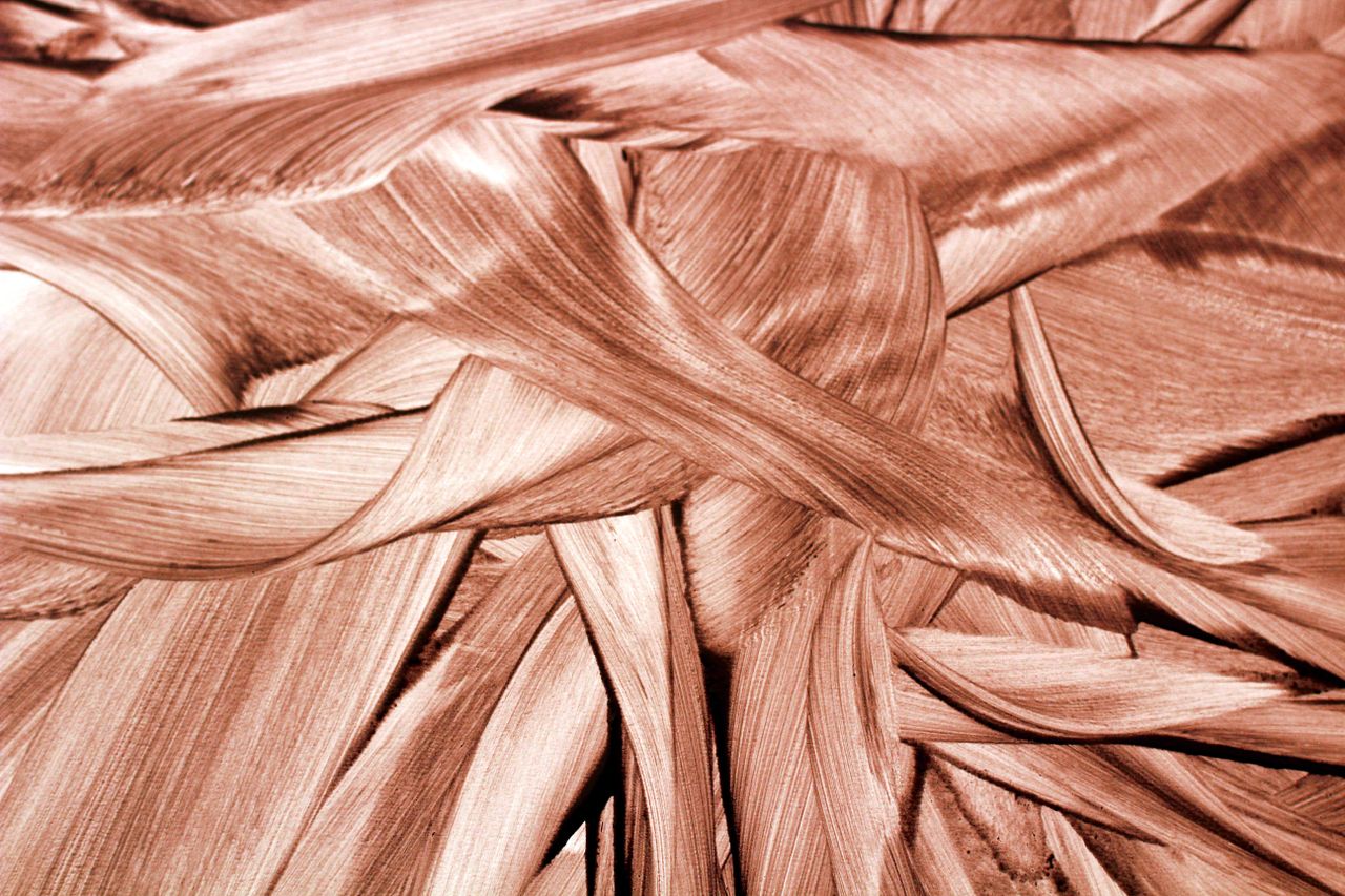 intricate abstract pattern of brown swirling brush strokes with a warm