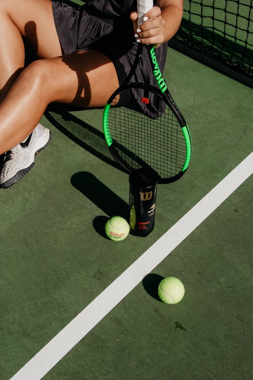 Green Tennis Balls and Black Racket