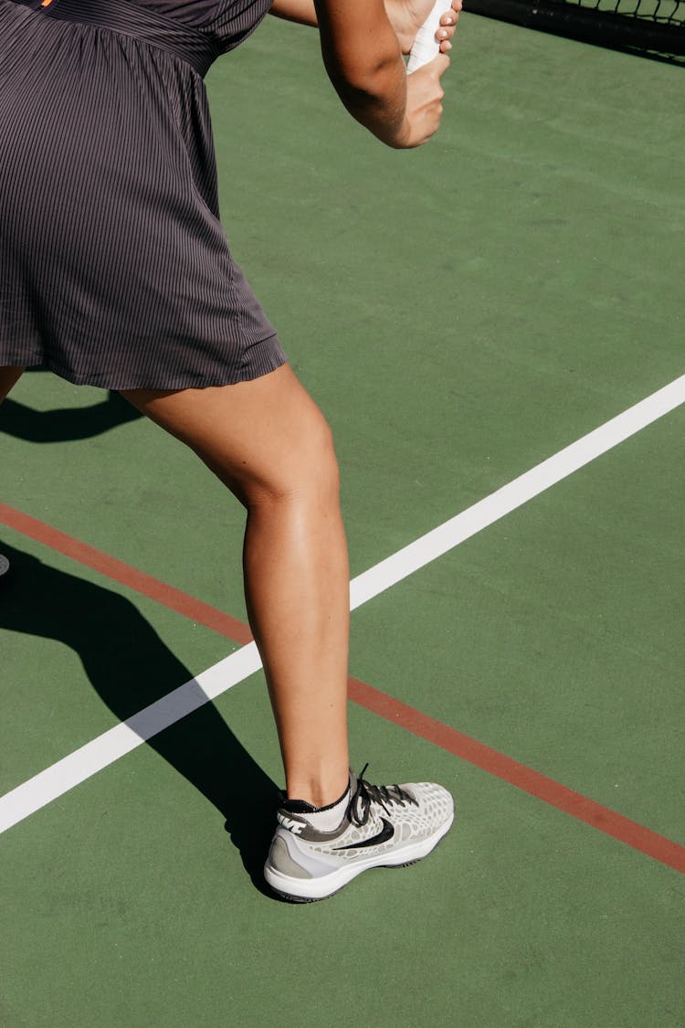 Close-up Photo Of Person Playing Tennis