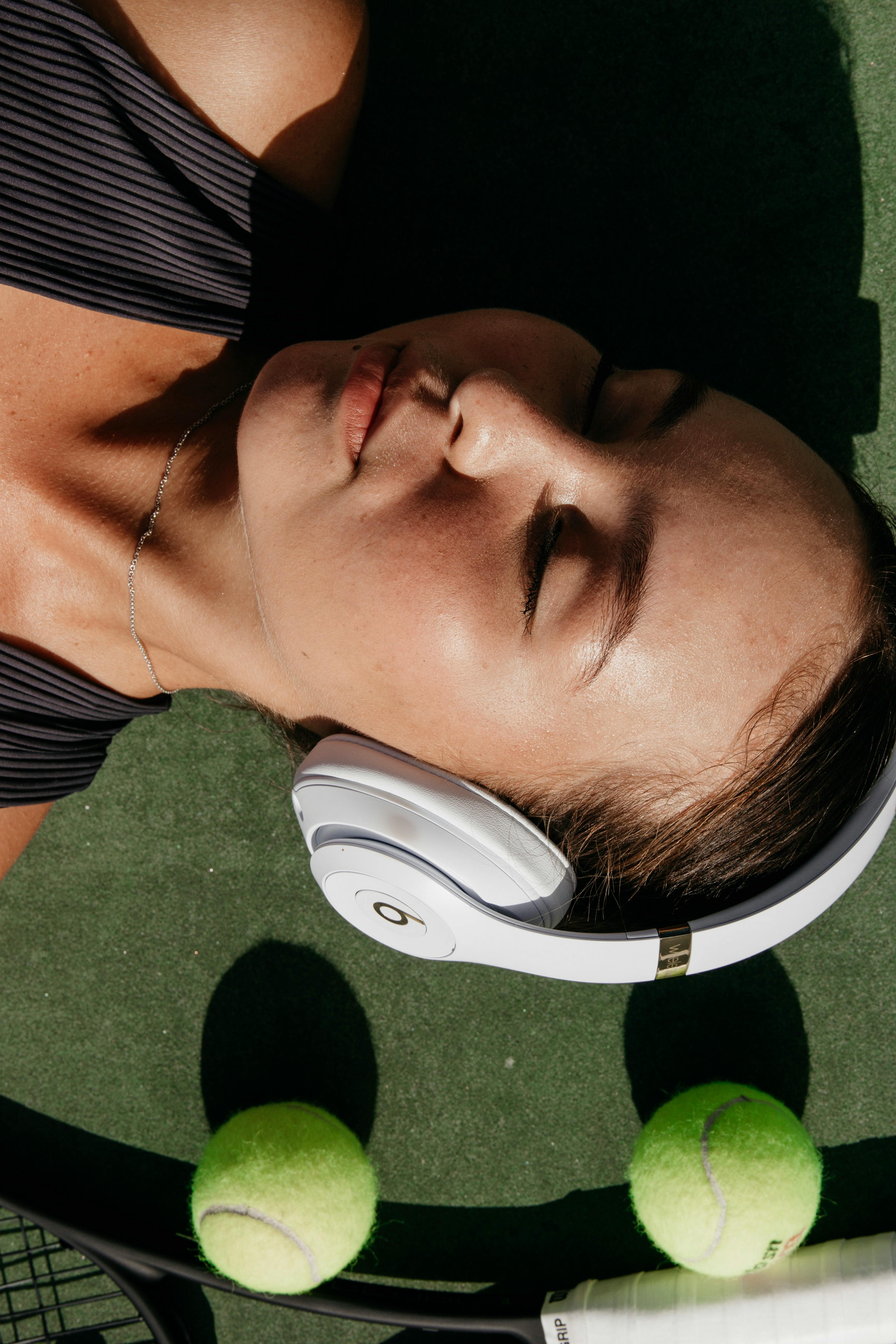 woman wearing white beats by dr dre wireless headset