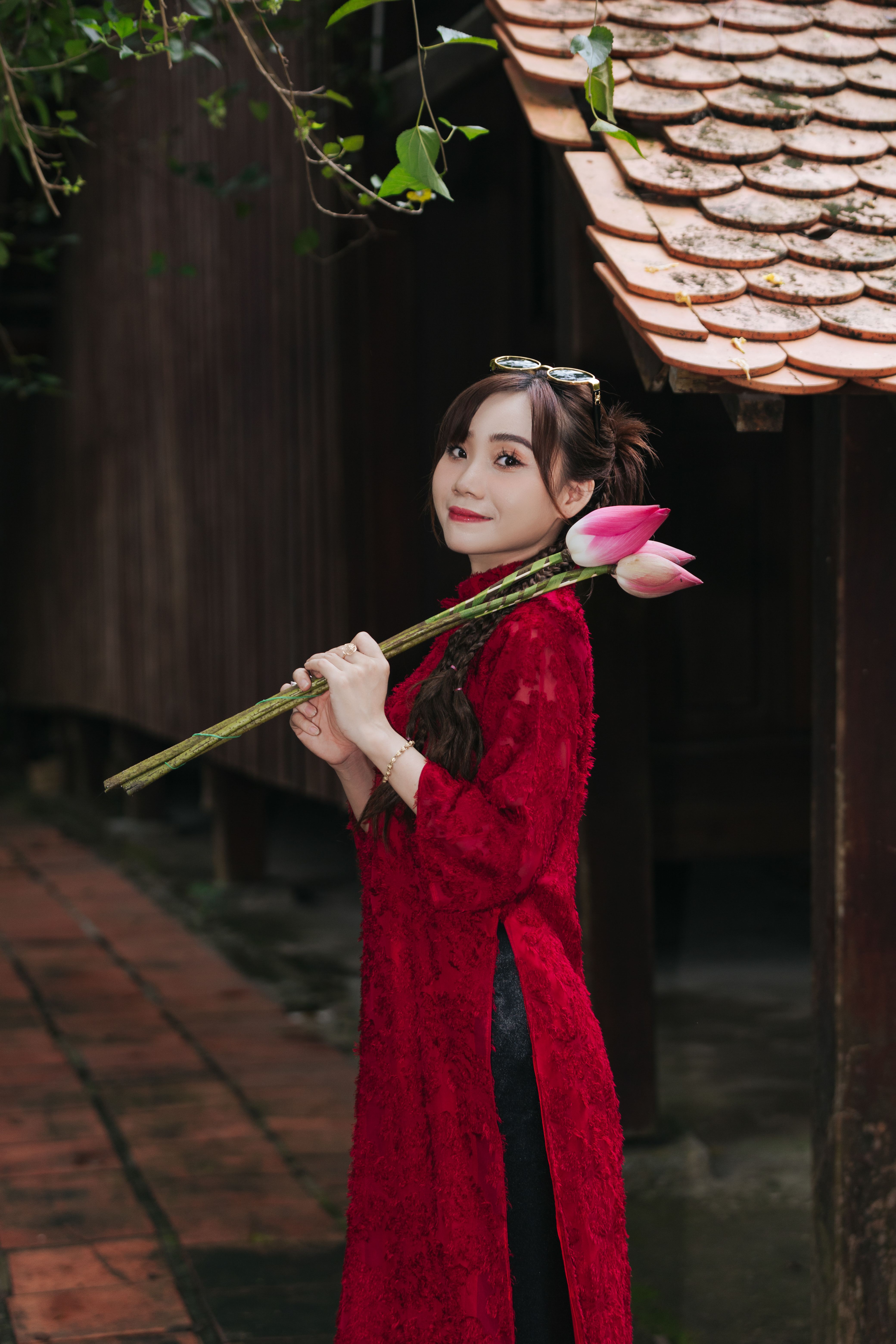 Woman in Red Dress Holding Lotus Flowers Outdoors · Free Stock Photo