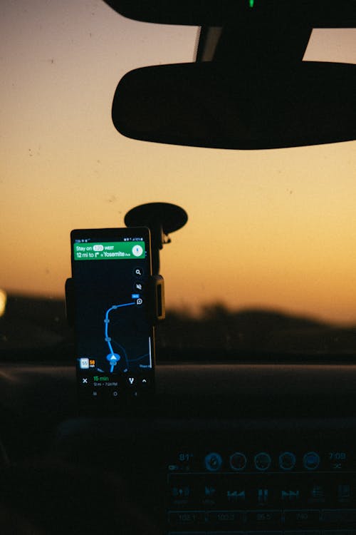 Free Smartphone Displaying Gps Map on Holder Inside Car Stock Photo