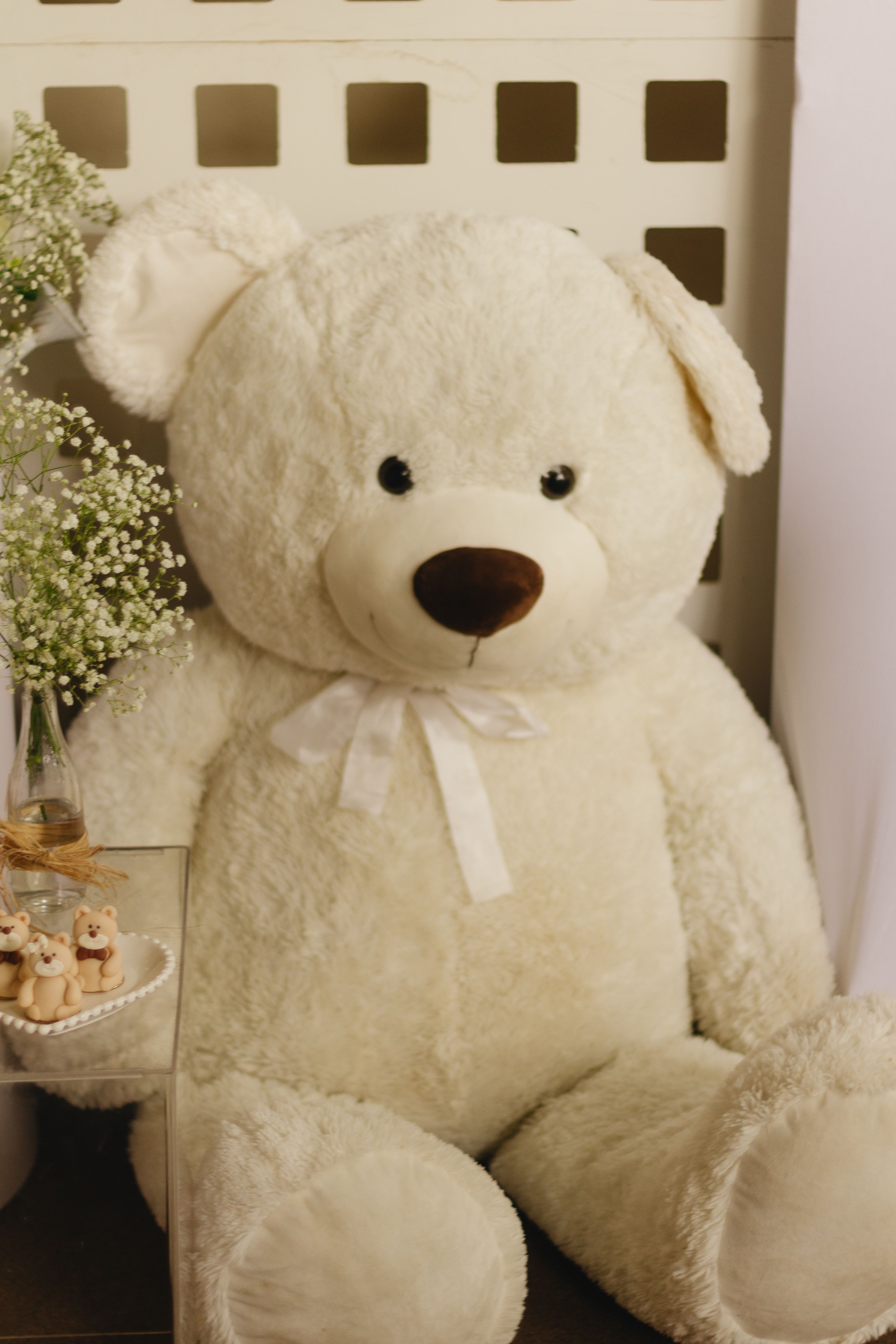 Large white teddy bear in a cosy indoor setting