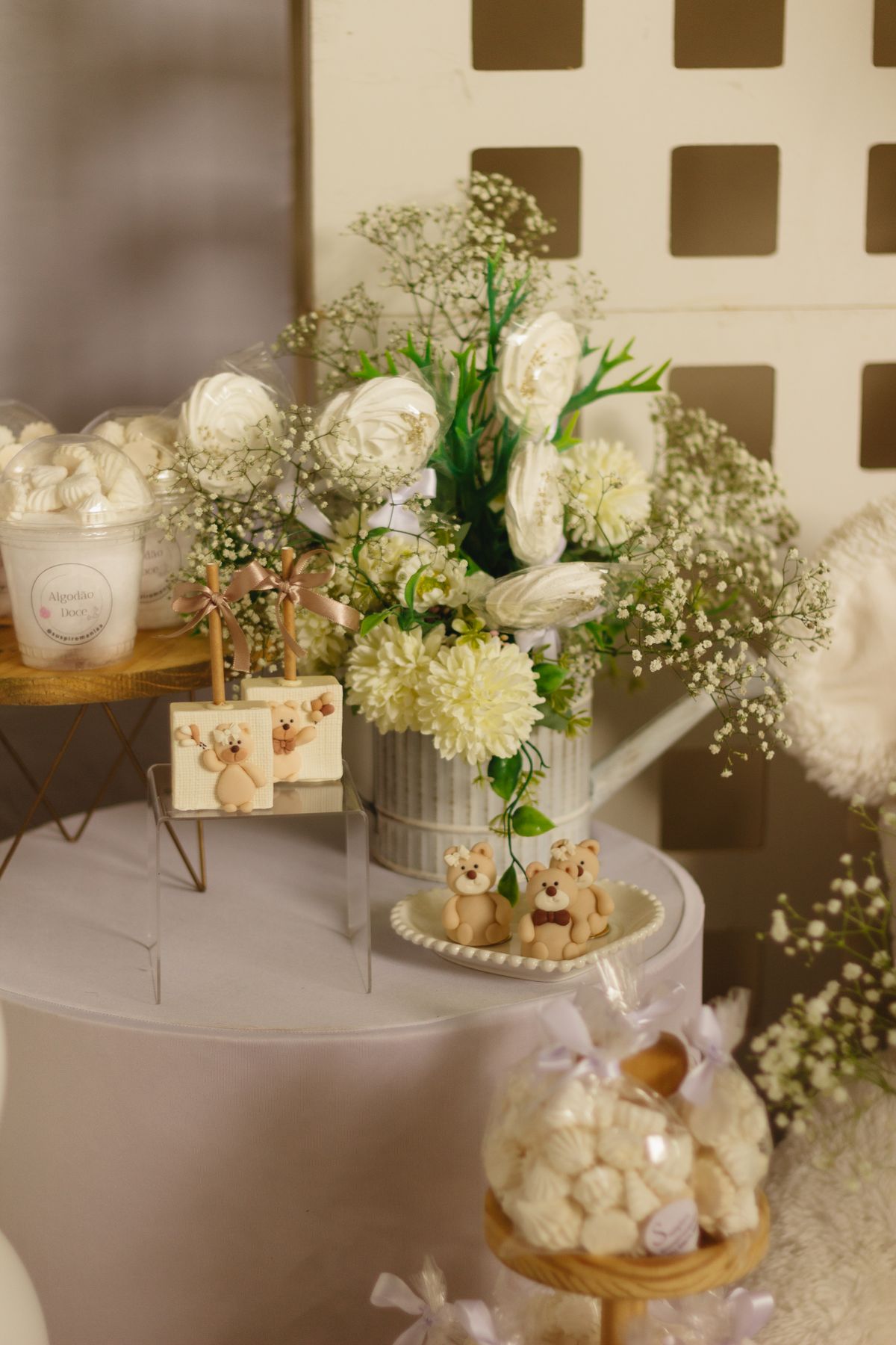 A charming table setting with white roses, baby's breath, and teddy bears, perfect for special occasions. Stock Photo.