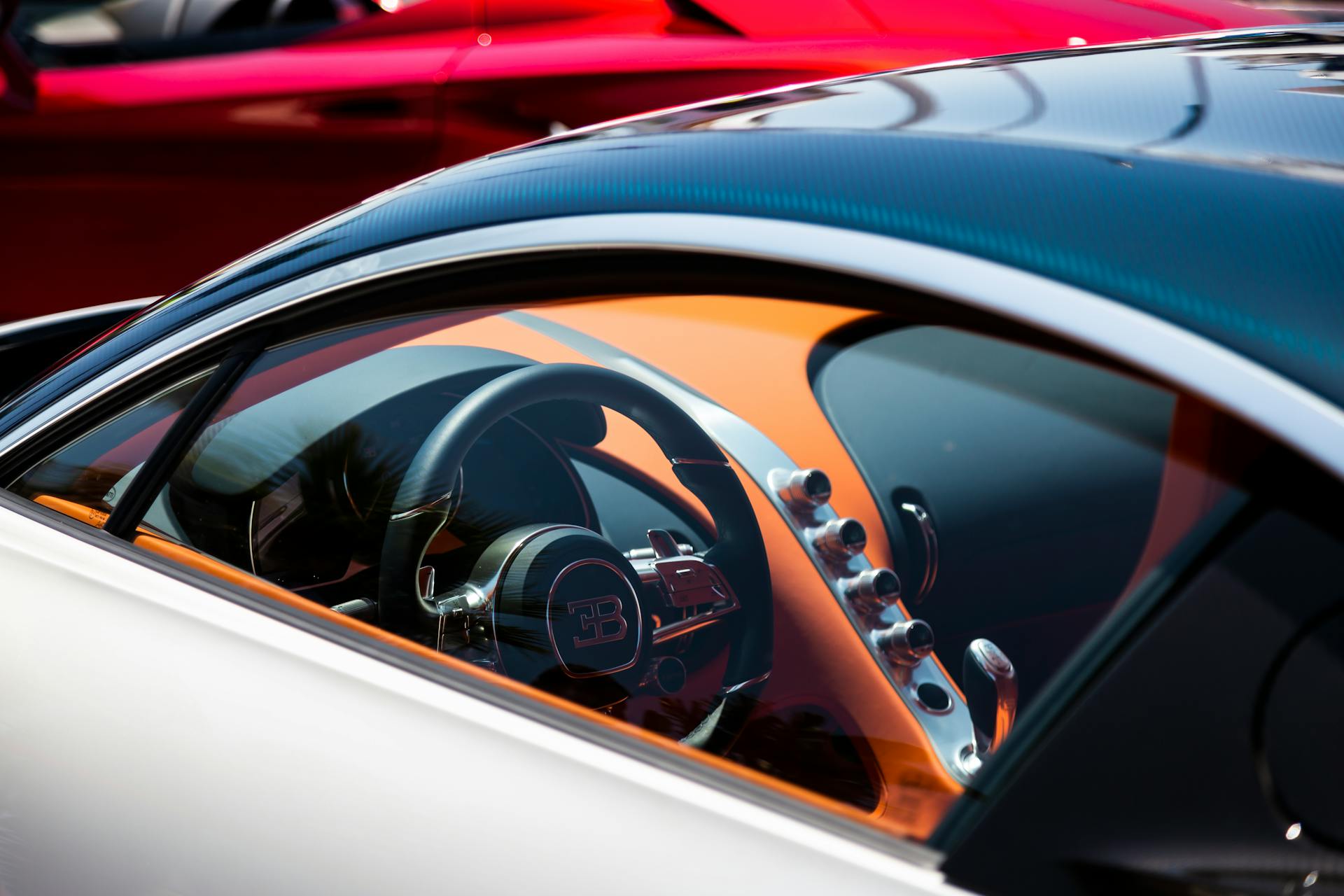 Detailed view of a luxury hypercar's steering wheel and interior with elegance and style.