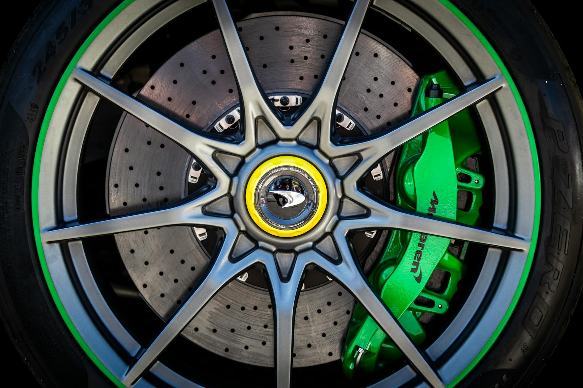 Detailed close-up of a luxury car wheel with a green brake caliper.