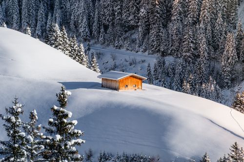 Free Wooden cabin surrounded by snowy landscapes in Zillertal, Tirol, Austria. Stock Photo