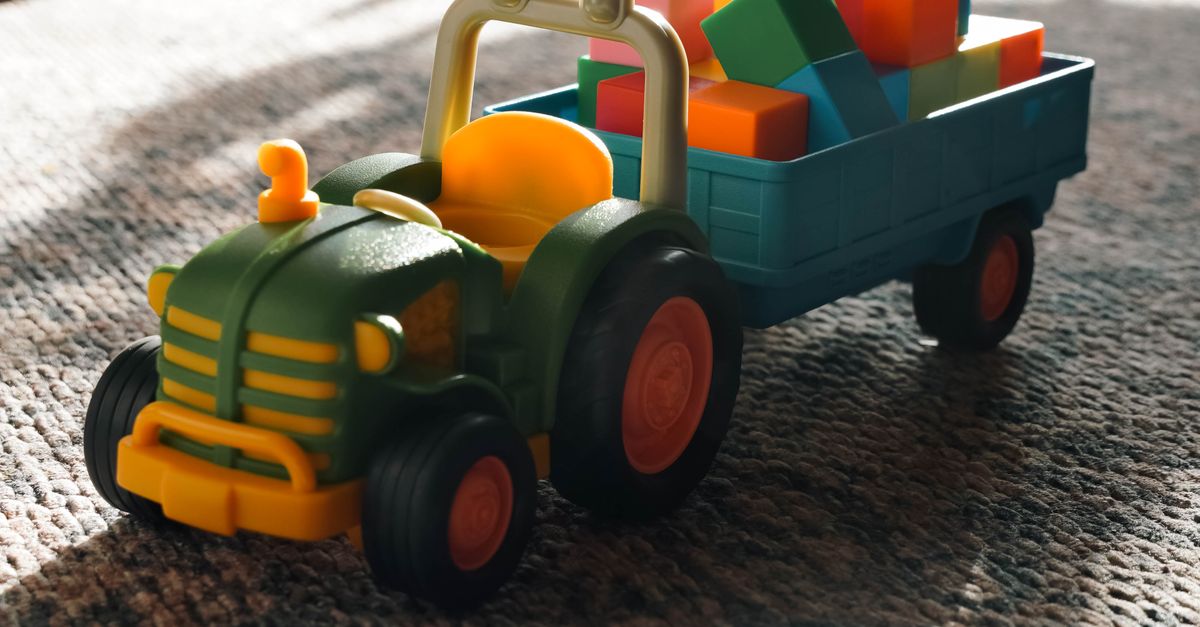 Tractor Play Rug Colorful Toy Tractor on Carpet in Sunlit Room · Free Stock Photo