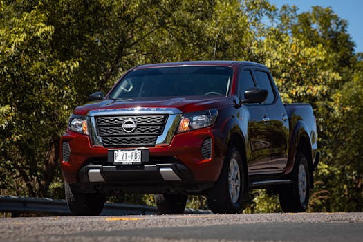 Powerful red pickup truck captured outdoors on a scenic road.