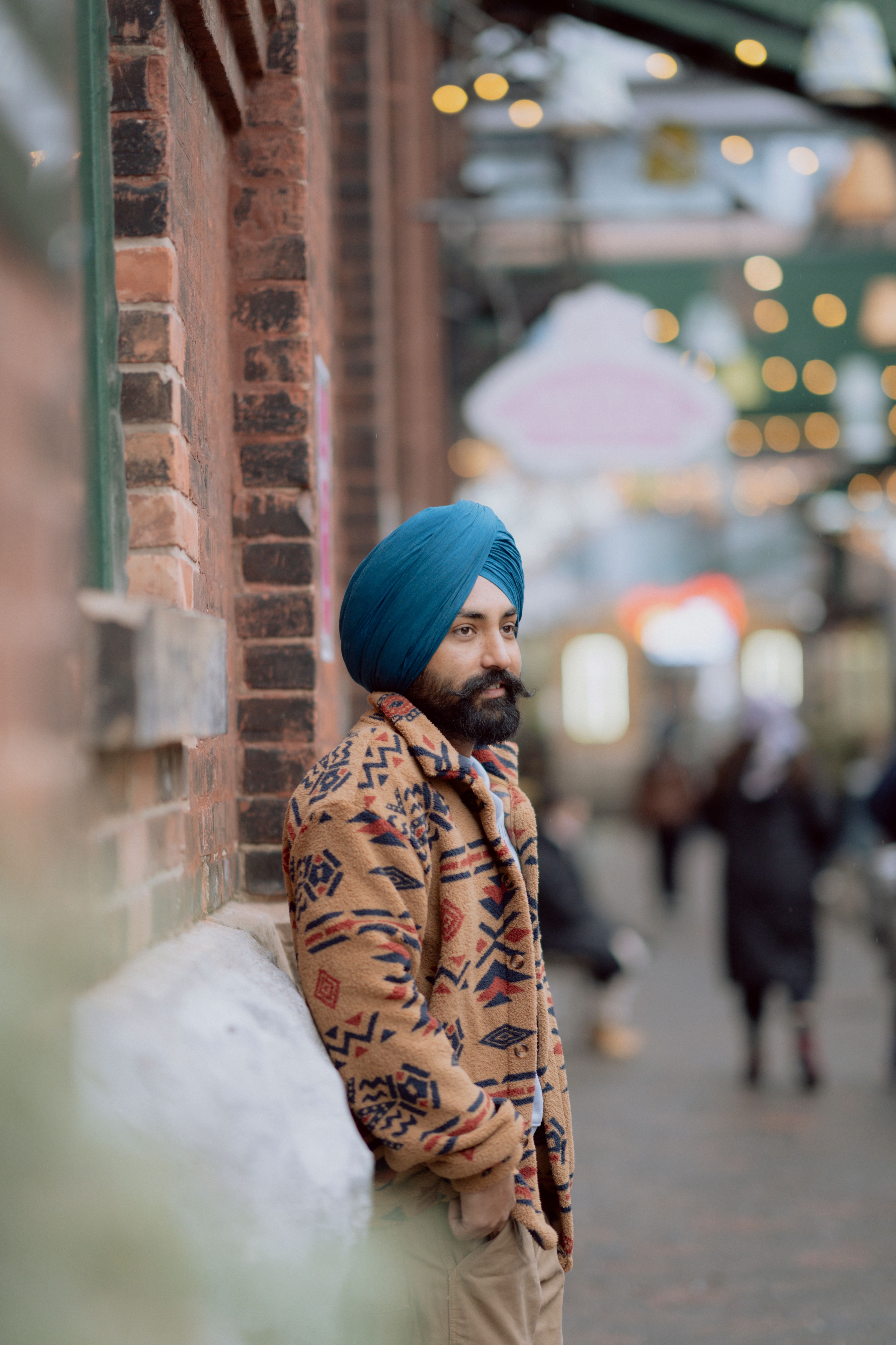 Man in Turban Leaning Against Urban Brick Wall · Free Stock Photo