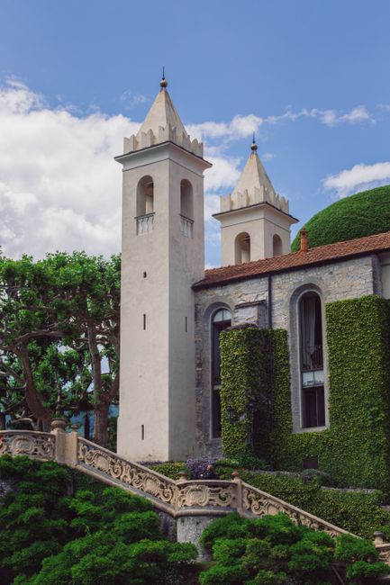 Capture of the iconic Villa del Balbianello towers with lush greenery in Lenno, Italy.
