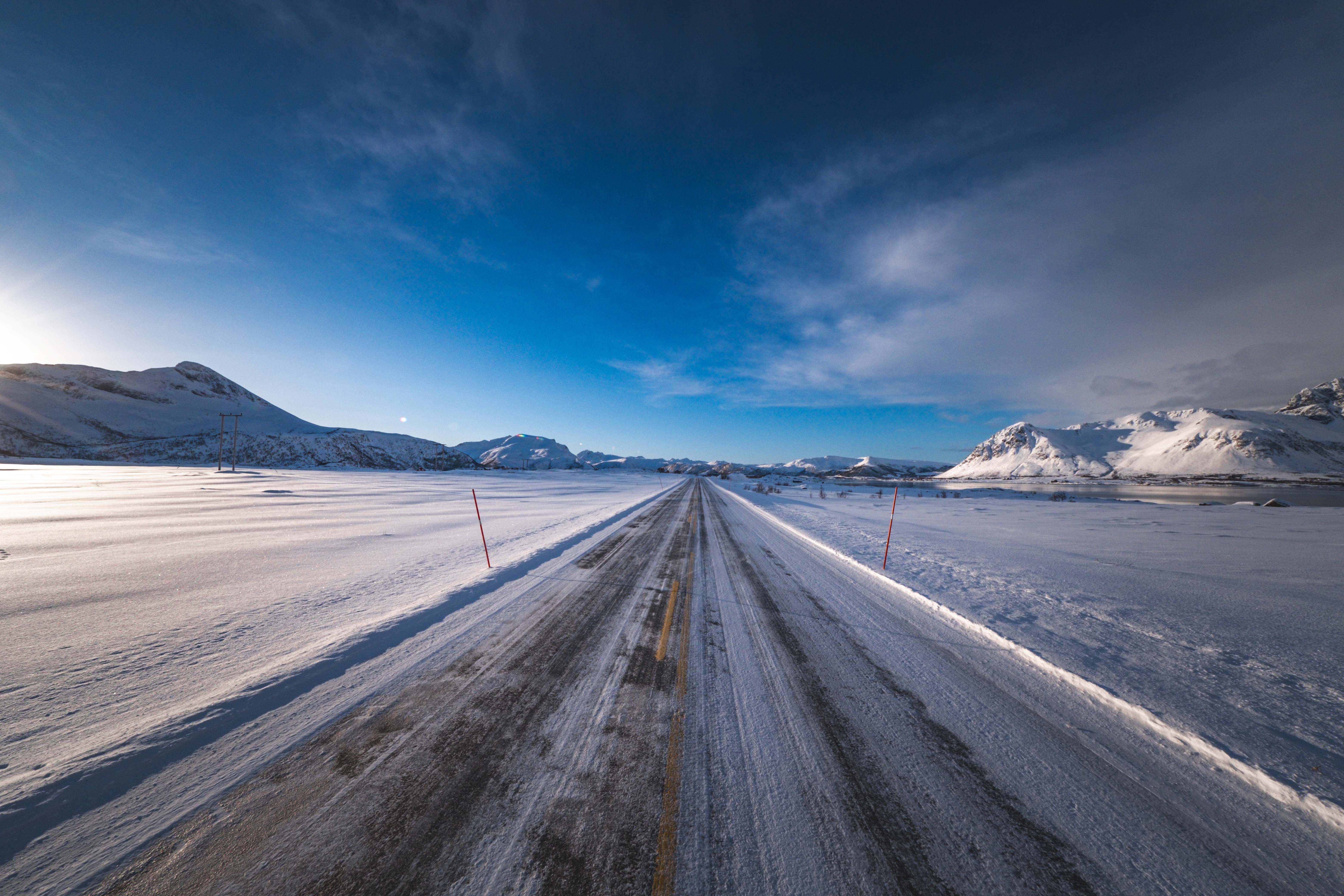 Scenic Winter Road Through Snowy Mountains · Free Stock Photo