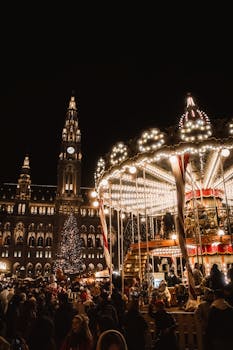 Vibrant carousel and crowd at Vienna's Christmas market with Rathaus in the background.