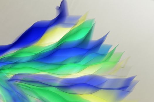 Dynamic abstract design with flowing colorful waves in blue, green, and yellow hues.