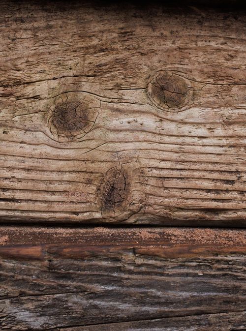Free A detailed view of weathered wooden planks showcasing knots and grain texture. Stock Photo