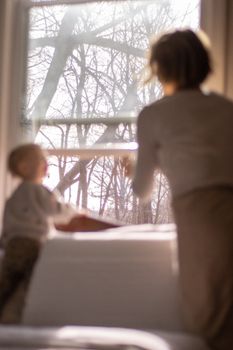 Warm family moment by a window with natural light streaming in.