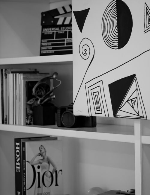 Free Stylish black and white geometric art alongside books and vintage camera. Stock Photo