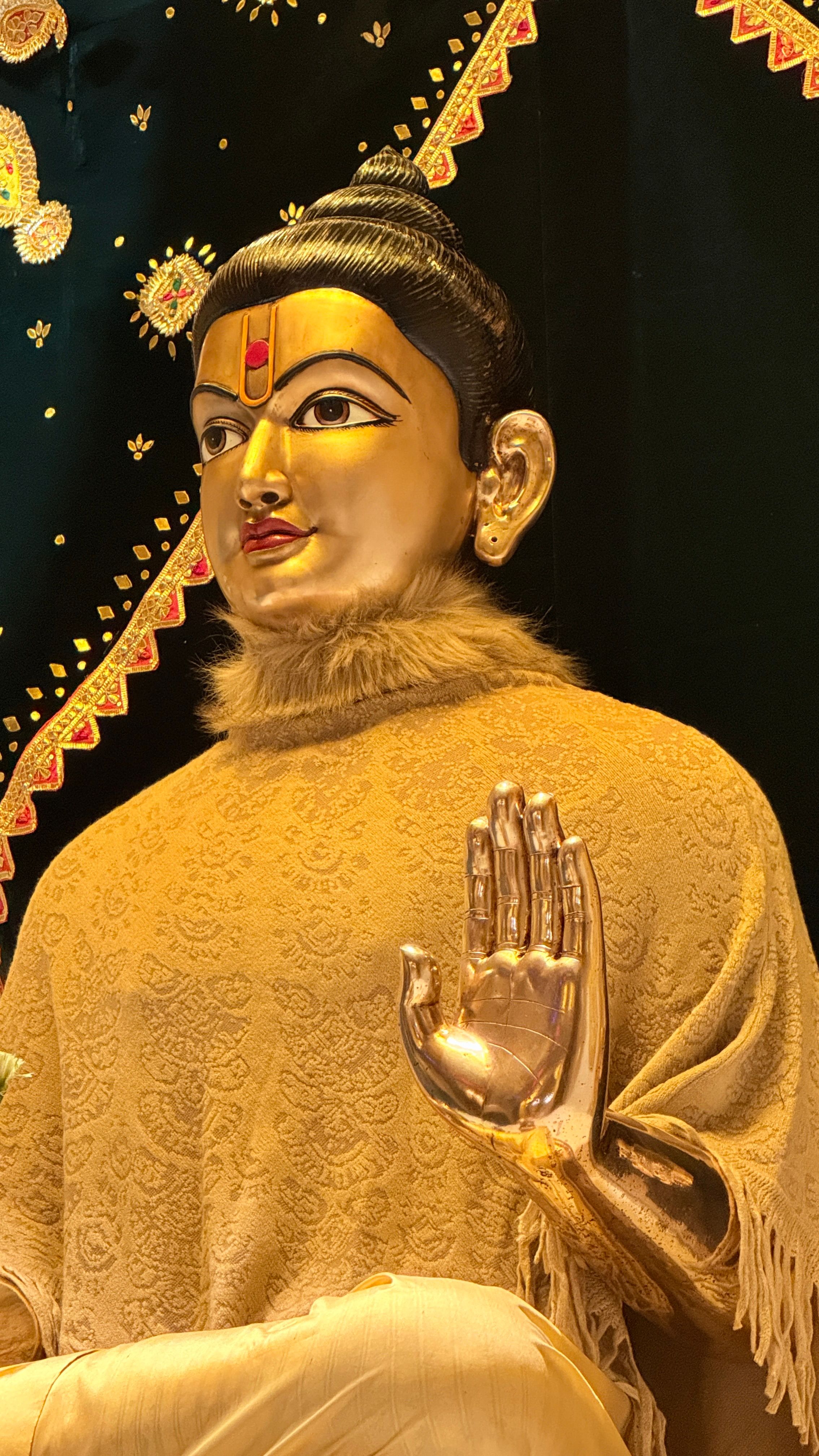 A detailed golden statue of a Hindu deity in Poicha, Gujarat, India, showing intricate craftsmanship.
