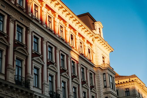 Free Sunlit facade of historic Viennese building showcasing intricate architecture during golden hour. Stock Photo