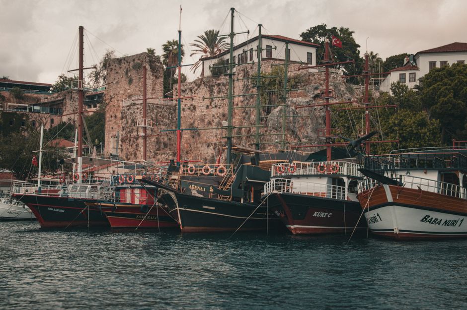 Ultimate ''Turkish Maldives'' Boat trip Adrasan-Suluada island from Antalya Review: Your Complete Guide to Turkey's Hidden Paradise Review 2026 - Scenic view of traditional Turkish ships docked in a historic harbor surrounded by ancient architecture.