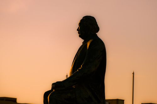 Free Silhouette of a statue against a vibrant sunset in Aktau, Kazakhstan. Stock Photo