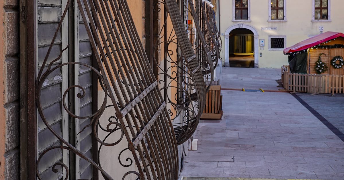 Charming Italian village alley with ornate railings · Free Stock Photo