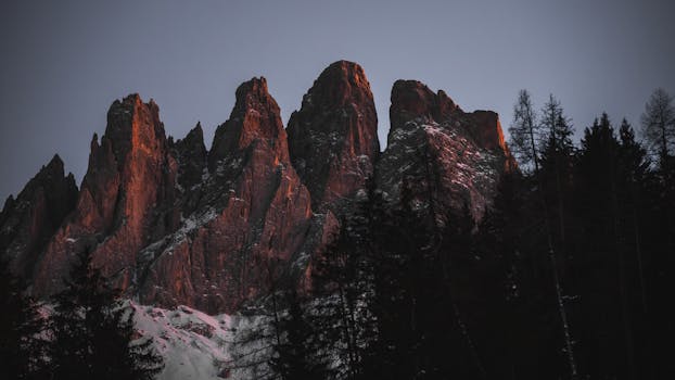 Breathtaking view of the Geisler mountain range in Trentino-Alto Adige during winter twilight.