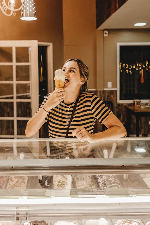 Woman Wearing Striped Shirt Holding Ice Cream