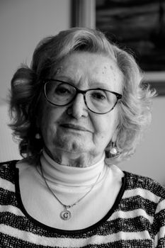 Charming black and white portrait of a stylish senior woman, conveying wisdom and elegance.