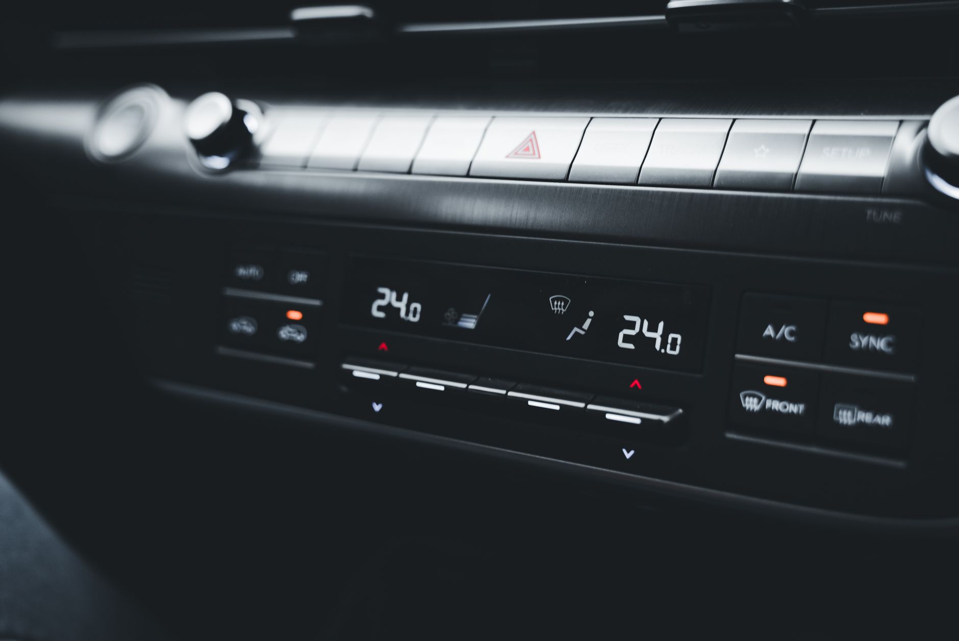 Close-up shot of a car's climate control system displaying temperature settings.