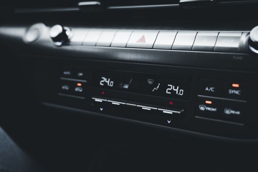 Close-up shot of a car's climate control system displaying temperature settings.